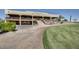 Attractive two-story clubhouse with lush landscaping and an inviting entrance for members and guests at 7762 E Russell Cir, Mesa, AZ 85207