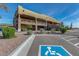 Welcoming clubhouse entrance with designated parking and beautiful desert landscaping at 7762 E Russell Cir, Mesa, AZ 85207