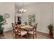 Elegant dining room featuring a wooden table with seating for six at 7762 E Russell Cir, Mesa, AZ 85207