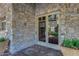The building's entrance features stone accents and double glass doors at 7762 E Russell Cir, Mesa, AZ 85207