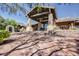 Stunning building entrance featuring stone accents, pavers, and lush greenery at 7762 E Russell Cir, Mesa, AZ 85207