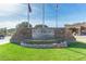 Elegant entrance sign to Las Sendas Golf Club with lush landscaping and flags at 7762 E Russell Cir, Mesa, AZ 85207