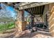 Outdoor gym area has a heavy bag and various exercise equipment under a covered patio at 7762 E Russell Cir, Mesa, AZ 85207