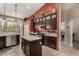 This spacious kitchen features an island, stainless steel appliances, tile floors, and dark cabinets at 7762 E Russell Cir, Mesa, AZ 85207