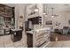 Bright and modern kitchen with stainless steel appliances and an open floor plan to the living area at 7762 E Russell Cir, Mesa, AZ 85207