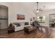 Inviting living room featuring desert artwork, a ceiling fan, and plenty of comfortable seating at 7762 E Russell Cir, Mesa, AZ 85207