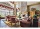 Comfortable lobby area with stone fireplace, high ceilings, and ample seating at 7762 E Russell Cir, Mesa, AZ 85207