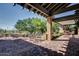 Charming outdoor patio with shaded seating and views of lush landscaping at 7762 E Russell Cir, Mesa, AZ 85207