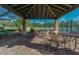 Covered patio seating offers views of community tennis courts and manicured landscaping at 7762 E Russell Cir, Mesa, AZ 85207