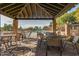 Covered patio seating area overlooks the sparkling community pool at 7762 E Russell Cir, Mesa, AZ 85207