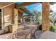 Covered patio area with multiple wrought iron tables and chairs for outdoor dining at 7762 E Russell Cir, Mesa, AZ 85207