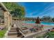 Relaxing poolside view with lounge chairs, tables, and shade umbrellas by the sparkling pool at 7762 E Russell Cir, Mesa, AZ 85207