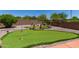 Beautiful backyard putting green with a bridge, sand traps, and desert landscaping providing a recreational retreat at 7762 E Russell Cir, Mesa, AZ 85207