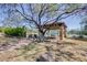 Community tennis court with shaded seating and lush greenery providing a picturesque setting at 7762 E Russell Cir, Mesa, AZ 85207