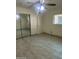 This bedroom features tile flooring, a large mirrored closet, and natural light from a window at 8110 N 31St Dr, Phoenix, AZ 85051