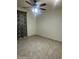 Bedroom with neutral walls, tile flooring, and a ceiling fan, providing a comfortable and inviting atmosphere at 8110 N 31St Dr, Phoenix, AZ 85051