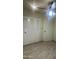 Bedroom featuring tile flooring, white closet doors and natural light from a ceiling fan at 8110 N 31St Dr, Phoenix, AZ 85051