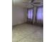 Bedroom features tile flooring, a ceiling fan, and windows with purple curtains at 8110 N 31St Dr, Phoenix, AZ 85051