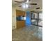 Living area featuring tile floors, partial kitchen view and sliding doors for indoor-outdoor living at 8110 N 31St Dr, Phoenix, AZ 85051