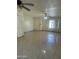 Open living room area with tile flooring and ceiling fans at 8110 N 31St Dr, Phoenix, AZ 85051