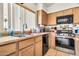 Clean kitchen featuring a sink, stainless steel appliances, and natural light from the window at 871 N Granada Dr, Chandler, AZ 85226