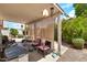 Covered patio with comfortable seating, providing an inviting outdoor space for relaxation and entertaining at 871 N Granada Dr, Chandler, AZ 85226