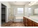 Bathroom with double sinks, a separate shower, and a soaking tub at 9563 E Keats Ave, Mesa, AZ 85209