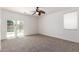 Bedroom with carpet, ceiling fan, white walls, and a door to the outside at 9563 E Keats Ave, Mesa, AZ 85209
