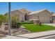 Landscaped front yard with artificial turf, stone accents, and desert plants at 9563 E Keats Ave, Mesa, AZ 85209