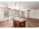 Kitchen island with a double sink and view into the living area at 9563 E Keats Ave, Mesa, AZ 85209
