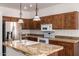Kitchen featuring granite countertops, stainless steel appliances, and wood cabinetry at 9563 E Keats Ave, Mesa, AZ 85209