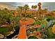 Aerial view of a beautifully landscaped community with lush greenery, tranquil ponds, and water features at 9707 E Mountain View Rd # 1408, Scottsdale, AZ 85258