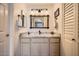 Stylish bathroom with granite countertops, wooden framed mirror, and updated fixtures at 9707 E Mountain View Rd # 1408, Scottsdale, AZ 85258