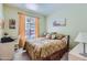 Comfortable bedroom with carpet and a queen bed, bathed in natural light at 9707 E Mountain View Rd # 1408, Scottsdale, AZ 85258