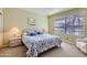 Comfortable bedroom featuring carpet, a window with blinds, and coordinating lamps at 9707 E Mountain View Rd # 1408, Scottsdale, AZ 85258