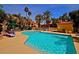 Sparkling community pool surrounded by lush landscaping and comfortable lounge chairs at 9707 E Mountain View Rd # 1408, Scottsdale, AZ 85258