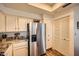 Bright kitchen with granite countertops, stainless steel refrigerator, and custom wine rack for a modern and stylish space at 9707 E Mountain View Rd # 1408, Scottsdale, AZ 85258