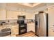 Cozy kitchen with granite counters, wood floors, stainless steel appliances, and bright white cabinets at 9707 E Mountain View Rd # 1408, Scottsdale, AZ 85258