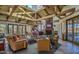 Inviting living room with high ceilings, stone fireplace, and wall of windows with scenic views at 9707 E Mountain View Rd # 1408, Scottsdale, AZ 85258