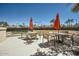 Outdoor patio area with tables, chairs, and umbrellas, perfect for relaxing and socializing at 9707 E Mountain View Rd # 1408, Scottsdale, AZ 85258