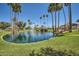Community pond featuring water fountain, mature trees, and green lawns at 9707 E Mountain View Rd # 1408, Scottsdale, AZ 85258