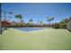 Well-maintained tennis court with blue and green surface and palm trees in the background at 9707 E Mountain View Rd # 1408, Scottsdale, AZ 85258