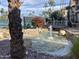 Water feature and landscaping with a tennis court in the background at 9707 E Mountain View Rd # 1408, Scottsdale, AZ 85258