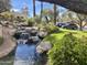 Scenic view of a water feature with rocks and trees in a community at 9707 E Mountain View Rd # 1408, Scottsdale, AZ 85258