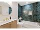 Bathroom featuring dark green tile, round mirror and modern vanity at 9708 E Via Linda Rd # 1350, Scottsdale, AZ 85258