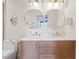 Bathroom vanity featuring double sinks, white countertops, and modern fixtures at 9708 E Via Linda Rd # 1350, Scottsdale, AZ 85258
