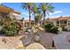 Beautifully landscaped community with mature trees, colorful flowers, and a rock-lined water feature enhancing curb appeal at 9708 E Via Linda Rd # 1350, Scottsdale, AZ 85258