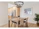 Bright dining area featuring stylish light fixture, natural light, and an open concept to the kitchen at 9708 E Via Linda Rd # 1350, Scottsdale, AZ 85258