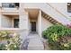 Charming entryway with desert landscaping, stairs, and a secure black metal screen door at 9708 E Via Linda Rd # 1350, Scottsdale, AZ 85258