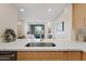 Stylish kitchen with quartz countertops, stainless steel sink, and an open view to the living area at 9708 E Via Linda Rd # 1350, Scottsdale, AZ 85258